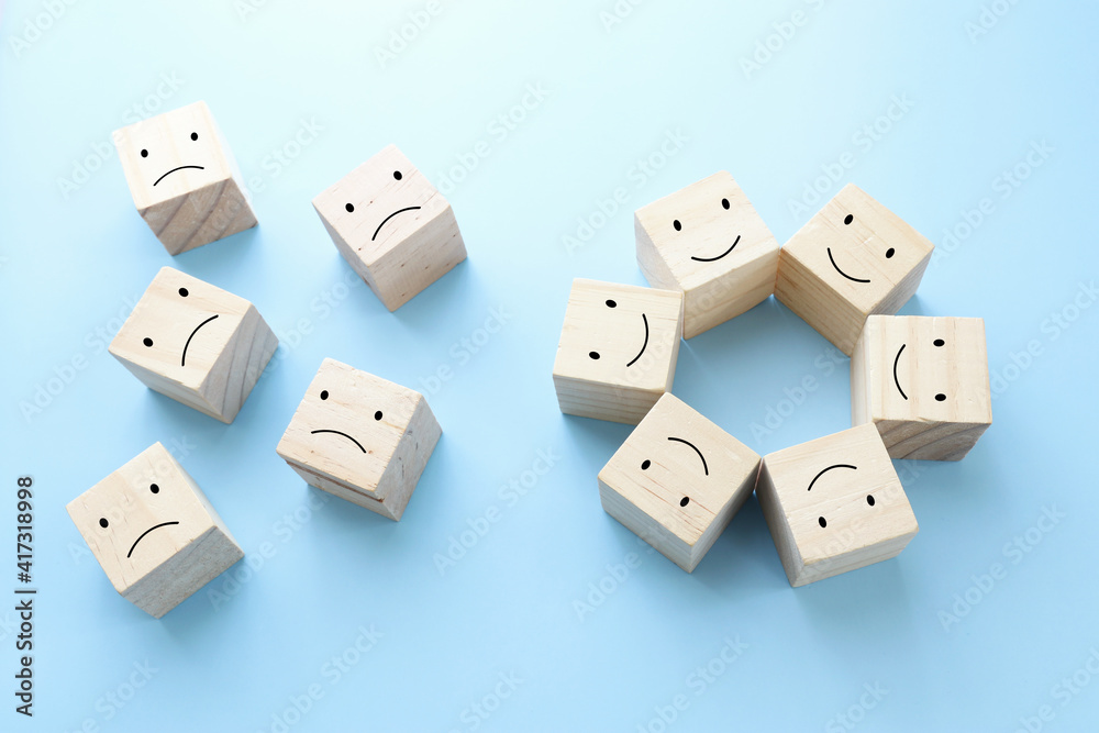 Concept image of satisfaction level. wooden cubes with emotions Concept image of satisfaction level. wooden cubes with emotions