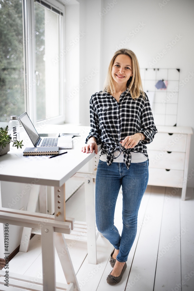 Businesswoman working at a standing desk in a modern office space