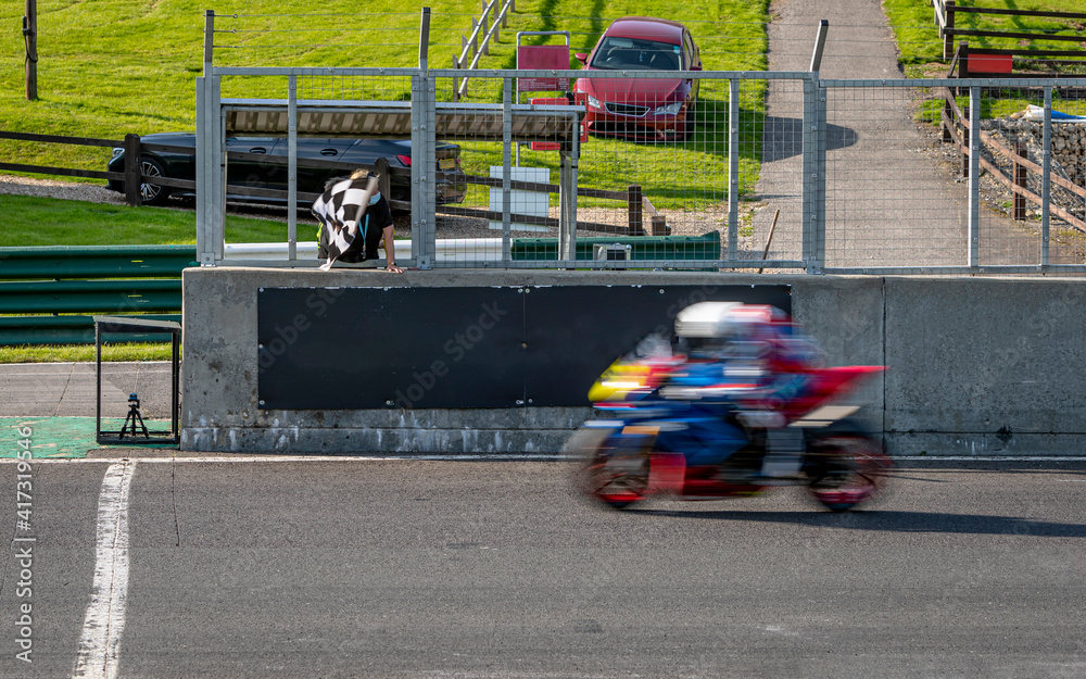 Fototapeta premium A shot of a racing motorbike as it circuits a track.