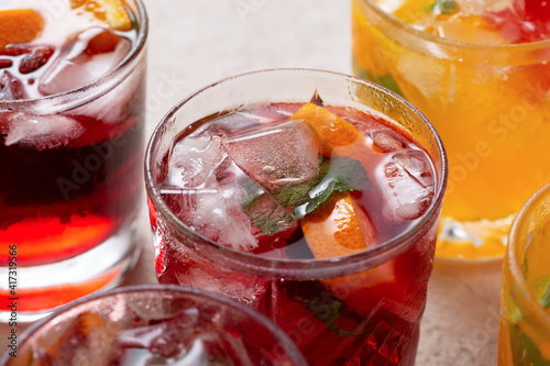 Detox drinks and cocktails with ice and fruits, close up