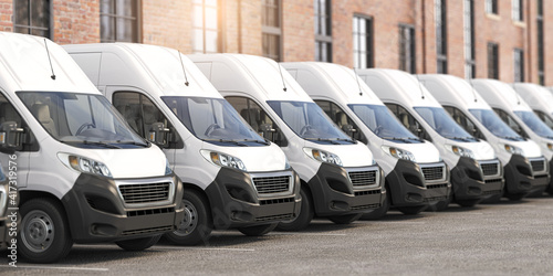 Delivery vans in a row.  Express delivery and shipment service concept. photo