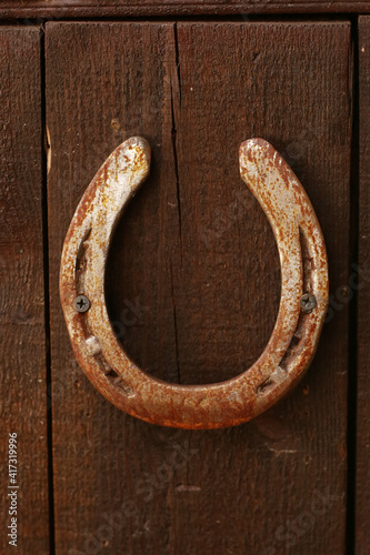 horse shoe close up photo on stable wall