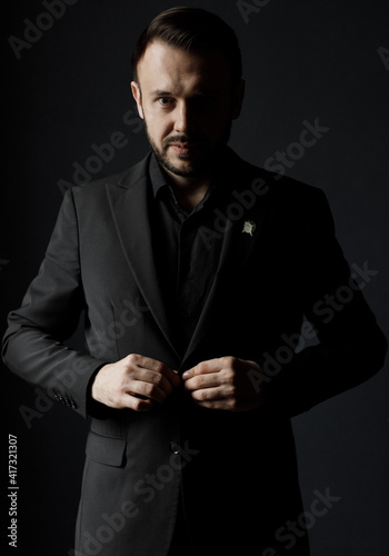 Portrait of a handsome man in black suit indoor