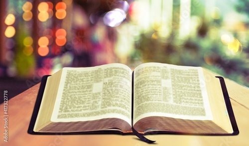 Open vintage christian bible on desk