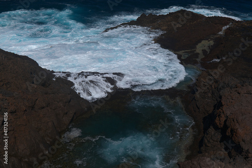 Gran Canaria, north coast, area around Punta Sardina cape, powerful foamy ocean waves breaking along the shore  © Tamara Kulikova