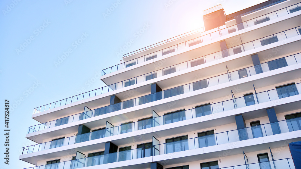 Fototapeta premium Apartment residential house and home facade architecture and outdoor facilities. Blue sky on the background. Sunlight in sunrise.