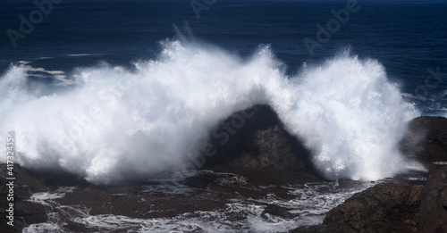 Gran Canaria  north coast  area around Punta Sardina cape  powerful foamy ocean waves breaking along the shore 