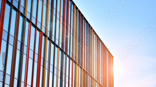Wallpaper Mural Blue curtain wall made of toned glass and steel constructions under blue sky. A fragment of a building. Glass facades on a bright sunny day with sunbeams in the blue sky. Torontodigital.ca