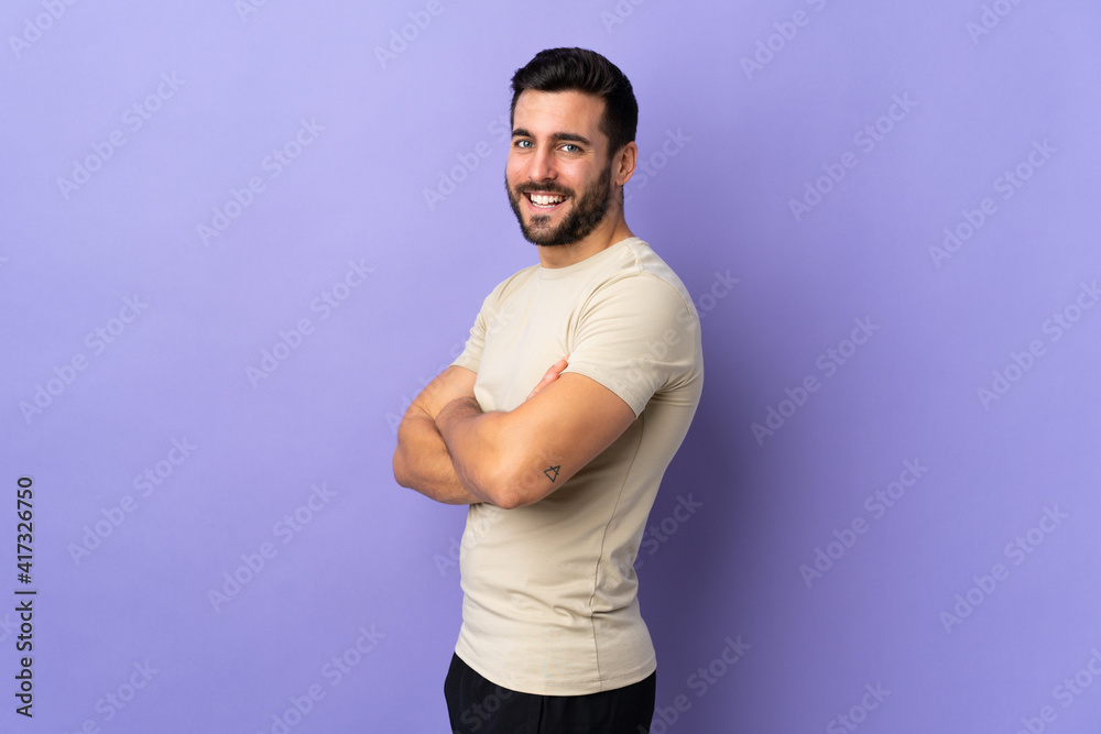 Young handsome man with beard over isolated background with arms crossed and happy Young handsome man with beard over isolated background with arms crossed and happy