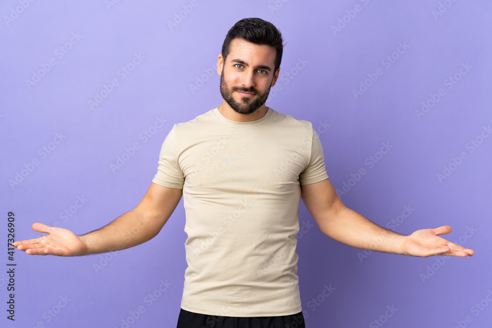 Young handsome man with beard over isolated background having doubts Young handsome man with beard over isolated background having doubts