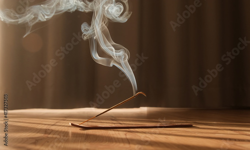 Burning aromatic incense smoky stick for meditation and relaxing. Aromatherapy smoke for yoga concept. photo