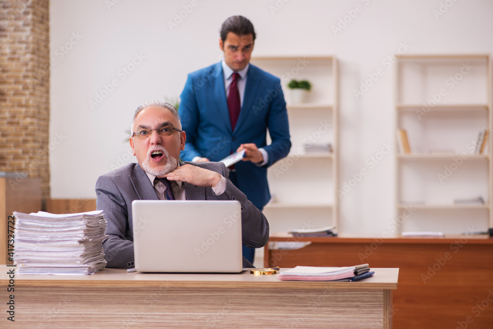 Two employees working in the office Two employees working in the office