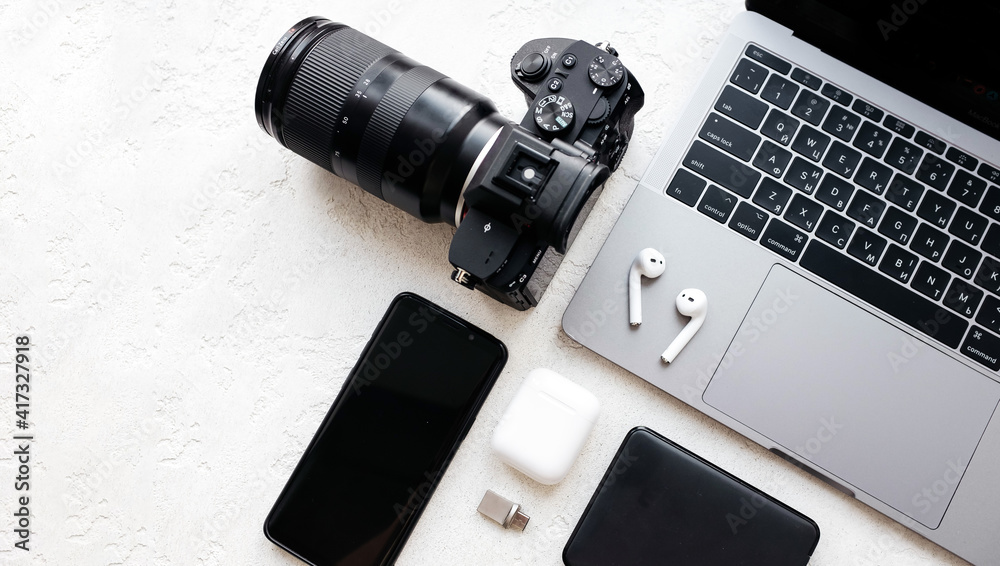 laptop, photocamera, telephone on a table mockup photographer office