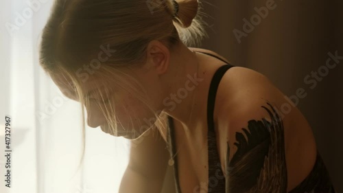 Tired woman after a hard workout sport is breathing deep heavily and has a difficulty breath dyspnea. Have a break after exercise.