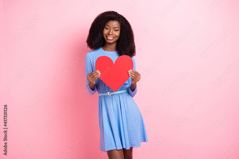 Photo of charming lady hold red heart figure toothy white smile wear blue dotted mini dress isolated pink color background Photo of charming lady hold red heart figure toothy white smile wear blue dotted mini dress isolated pink color background