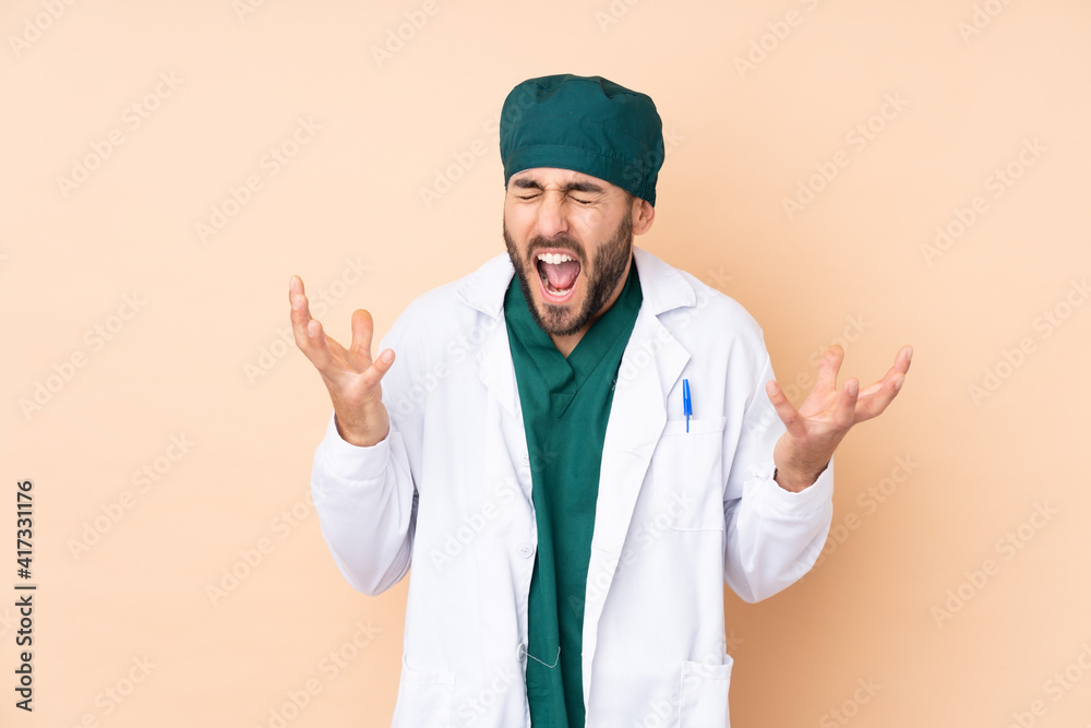 Surgeon man isolated on beige background unhappy and frustrated with something Surgeon man isolated on beige background unhappy and frustrated with something