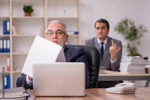 Two employees sitting at workplace