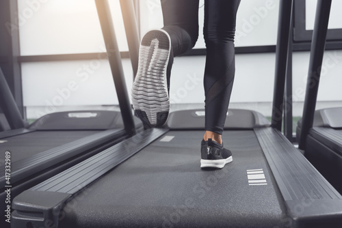 Legs woman running on treadmill.