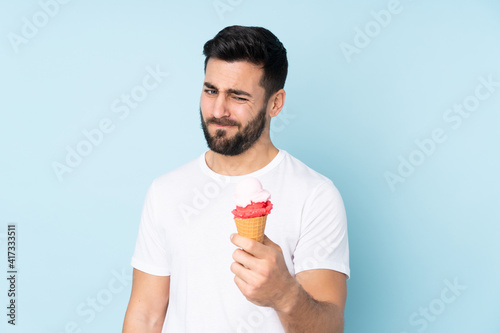 Caucasian man with a cornet ice cream isolated on blue background
