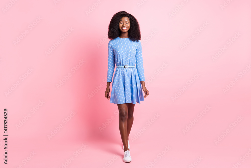 Photo of charming lady look camera walk wear blue dotted mini dress sneakers isolated pink color background Photo of charming lady look camera walk wear blue dotted mini dress sneakers isolated pink color background