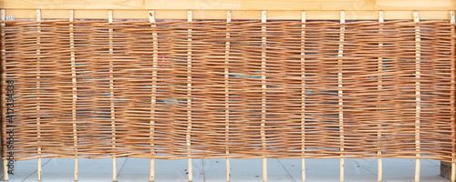 he texture of a pale brown wicker fence