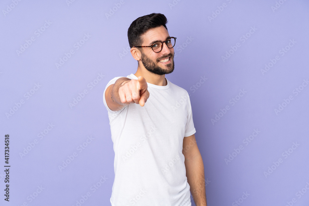 Caucasian handsome man over isolated background pointing front with happy expression Caucasian handsome man over isolated background pointing front with happy expression