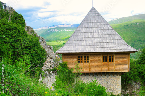 The magnificent panoramic view of the mountain valley of Una river and traditional village Kulen Vakuf from the top of ruined castle Ostrovica photo