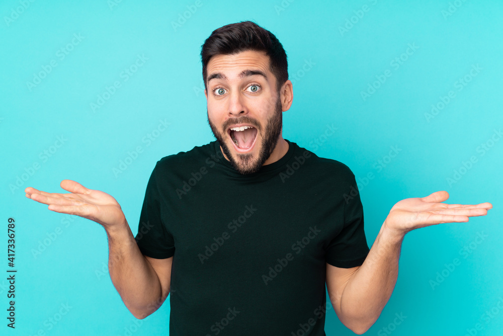 Caucasian handsome man isolated on blue background with shocked facial expression Caucasian handsome man isolated on blue background with shocked facial expression