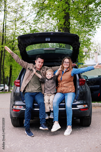 Happy family with  son on  background of  trunk of  SUV © DariaTrofimova