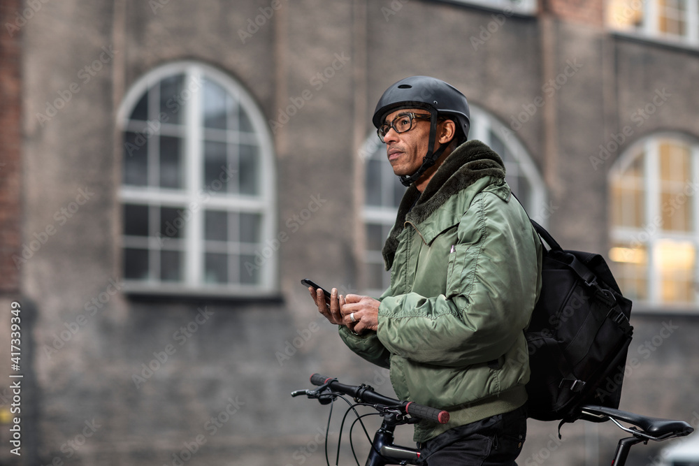 Bicycle courier using cell phone Bicycle courier using cell phone