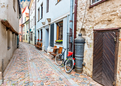 Narrow street in old European town. Walking through medieval streets of old E...