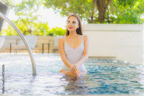 Portrait beautiful young asian woman smile relax leisure around swimming pool