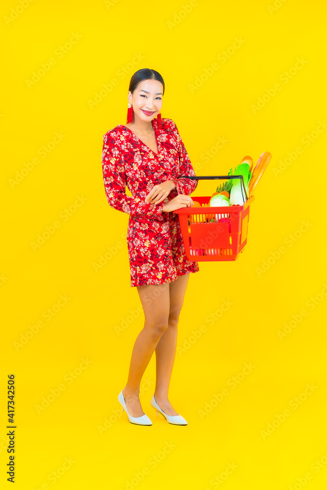 Portrait beautiful young asian woman with grocery in basket and cart Portrait beautiful young asian woman with grocery in basket and cart