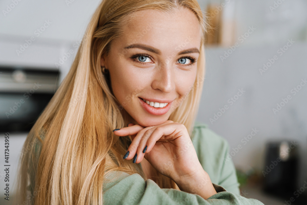 Happy blonde young woman smiling and looking at camera Happy blonde young woman smiling and looking at camera