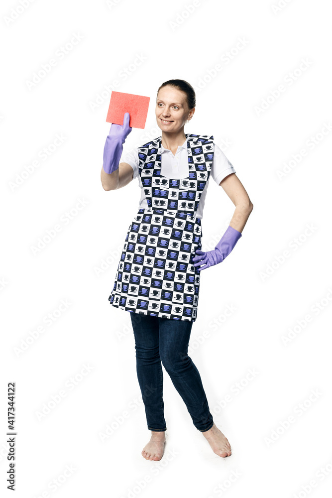 A beautiful young woman in the uniform of a maid holds a rag for washing windows. Isolated on a white background. Washes glass. A beautiful young woman in the uniform of a maid holds a rag for washing windows. Isolated on a white background. Washes glass.