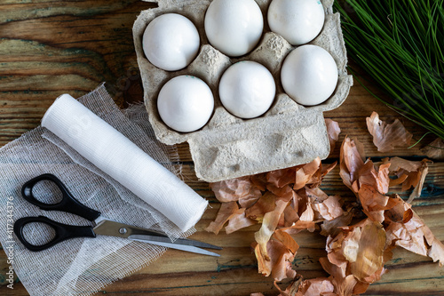 Preparing for egg coloring in onion skin for Easter, meterials on the table photo