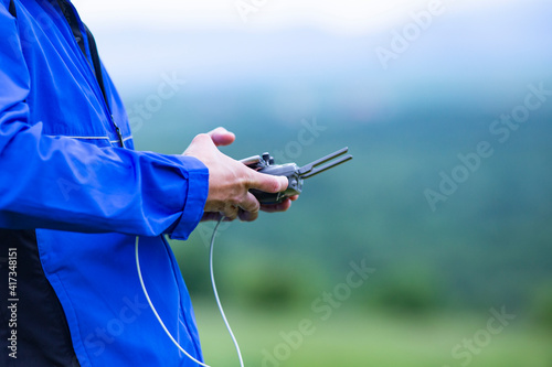 Quadro em tela Closeup of male hands operating a drone remote controller