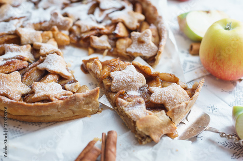 Traditional apple pie on the table with decorations.