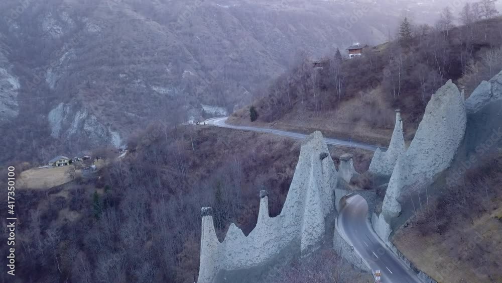 Aerial forward over Euseigne pyramids and surrounding landscape. Switzerland