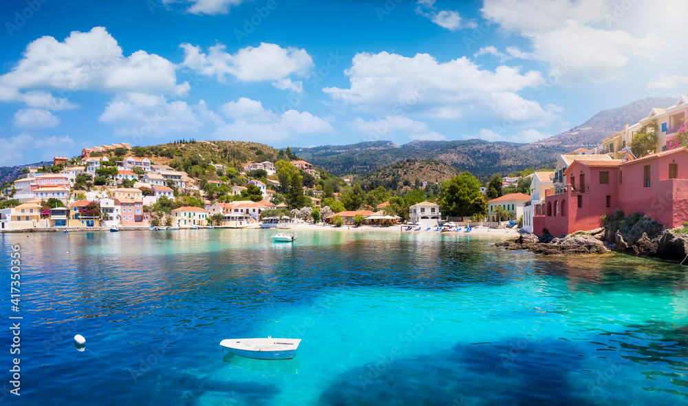 The beautiful fishing village of Assos on the Ionian island of Cephalonia, Greece, with emerald sea and colorful, red roofed houses along the hills
