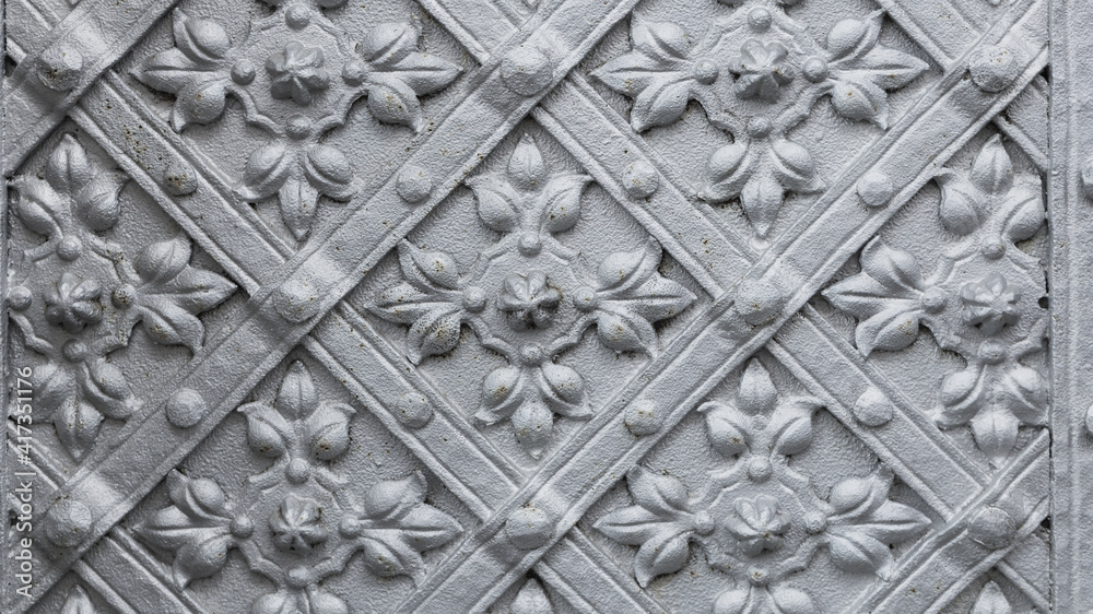 old metal door with cast patterns detail