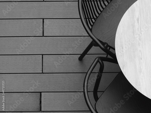 circular wooden table with metal chair on the wood floor, black and white style