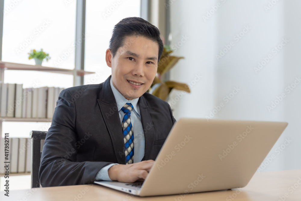 Smart asian businessman working with laptop at office. Smart asian businessman working with laptop at office.