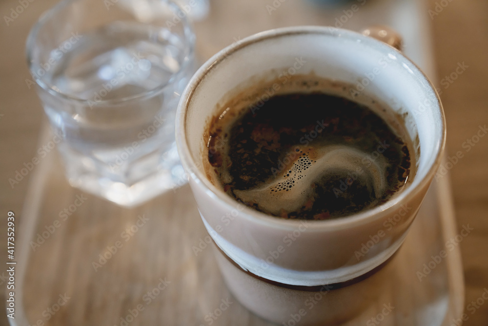 Middle aged man's hands holding a cup of espresso coffee Middle aged man's hands holding a cup of espresso coffee