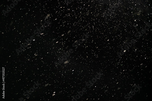 Snow against a black sky. Snow on a black background. Snow background.