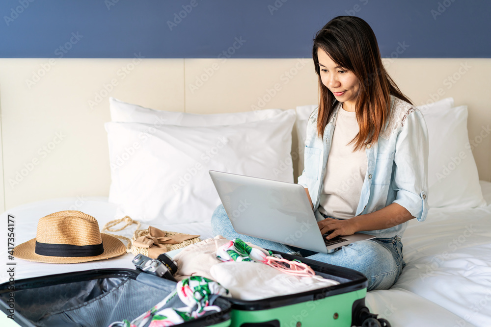 Young women planning summer vacation trip and searching information or booking hotel on laptop, Travel concept Young women planning summer vacation trip and searching information or booking hotel on laptop, Travel concept