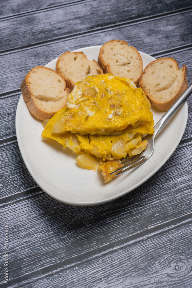 Spanish omelette with potatoes and onion, typical Spanish cuisine. Spanish tortilla. Dark wood background Spanish omelette with potatoes and onion, typical Spanish cuisine. Spanish tortilla. Dark wood background