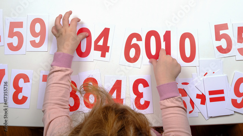 education a child count with plastic cards with numbers,childhood autism