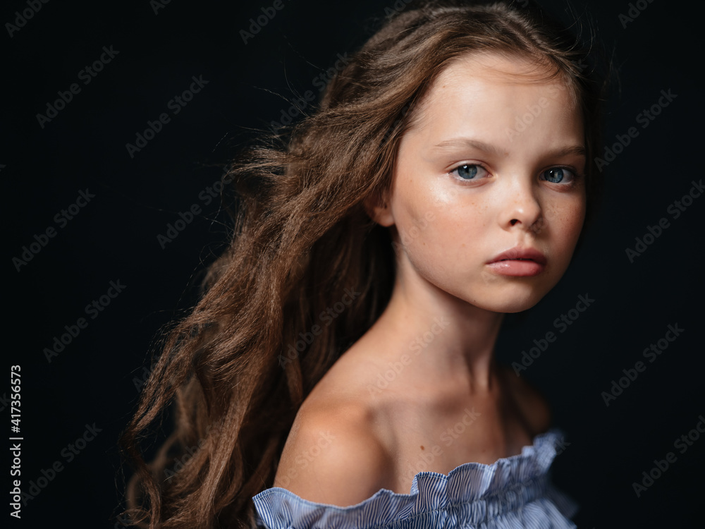 A beautiful Girl in a dress with bare shoulders And a hairstyle on a ...