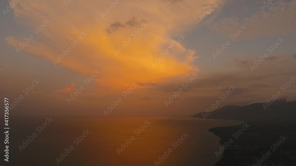 Sea coast at sunset. Aerial view of sunset on the ocean coast, mountains, sea, beach, sky, clouds. Bali, Indonesia. Sunset on the island of Bali. 4K, Aerial footage Sea coast at sunset. Aerial view of sunset on the ocean coast, mountains, sea, beach, sky, clouds. Bali, Indonesia. Sunset on the island of Bali. 4K, Aerial footage